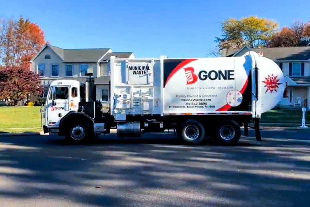 sideload garbage truck on a route in a Montgomery County neighborhood